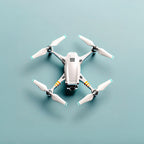 White drone with propellers on a light blue background