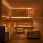 Interior of a dimly lit sauna with wooden benches and warm lighting.